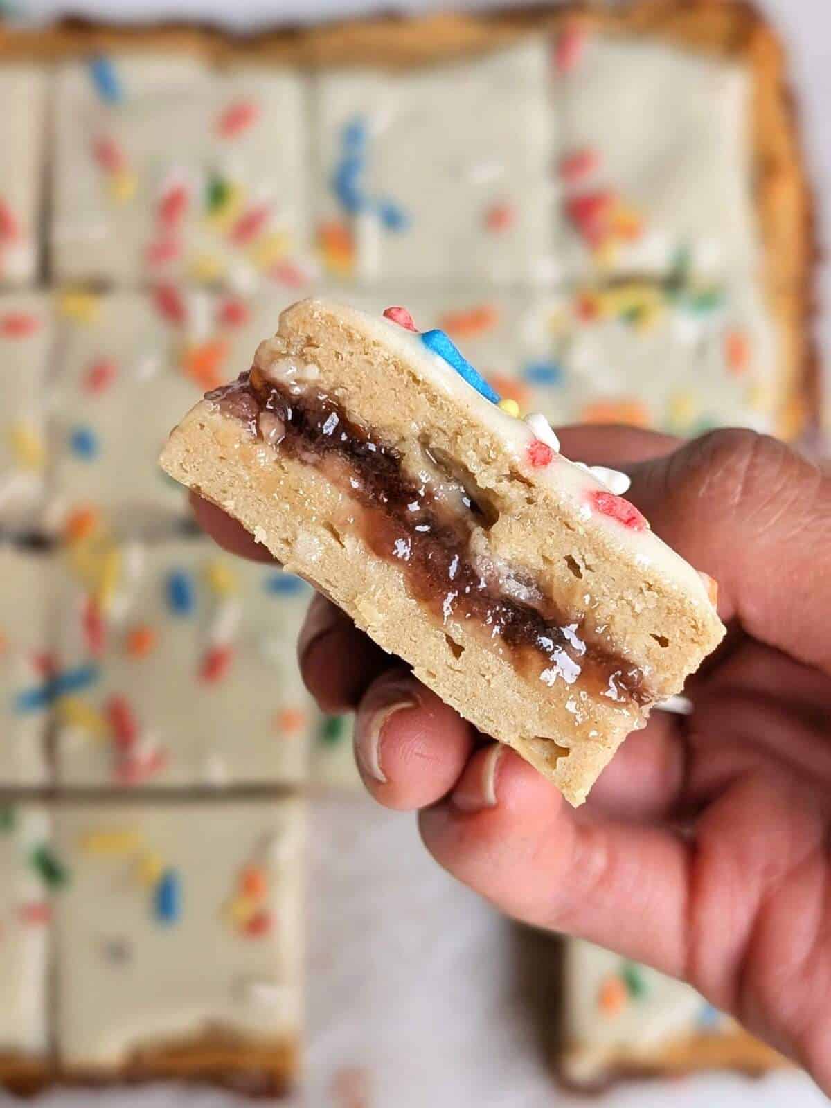 Make healthy cravings a reality with the ultimate Strawberry Top Tart Protein Bars recipe! These macro-friendly, low-sugar and low fat bars taste just like the real deal but are packed with protein and no guilt.