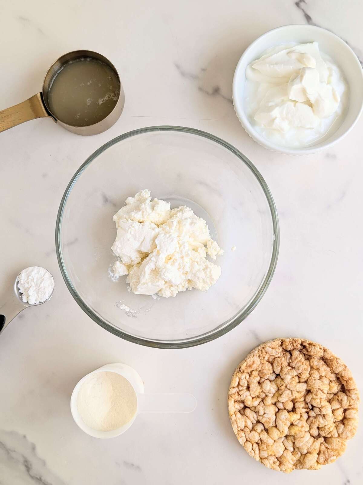 Indulge in this macro-friendly High Protein Cheesecake with Rice Cake Crust. An easy recipe with no extra sugar and creamy flavor for your fitness goals.