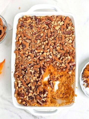 High protein sweet potato casserole is the best healthy Thanksgiving dessert recipe. A sweet potato souffle base with protein powder and a topping with protein pretzels - delicious and macro-friendly!