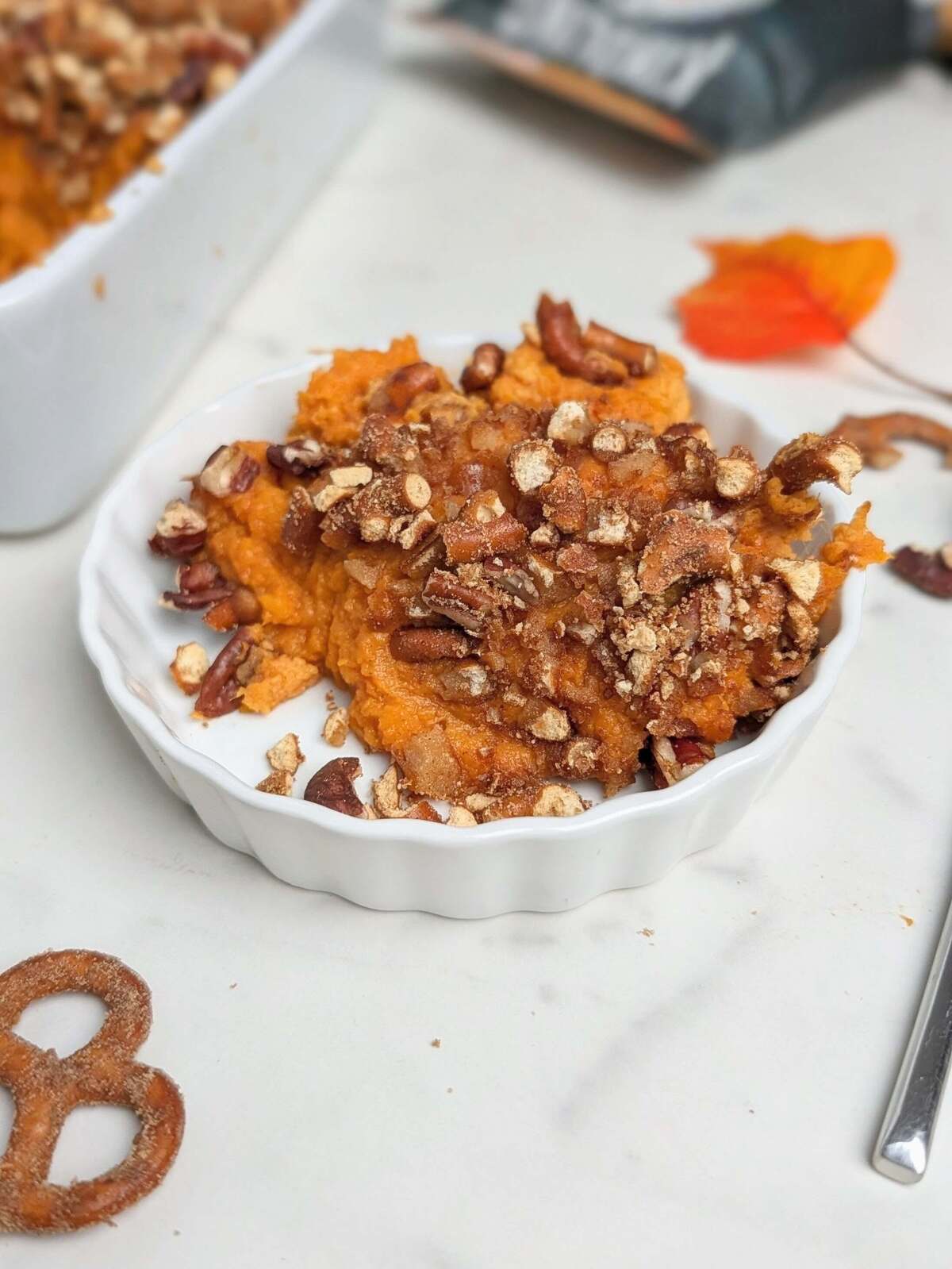 High protein sweet potato casserole is the best healthy Thanksgiving dessert recipe. A sweet potato souffle base with protein powder and a topping with protein pretzels - delicious and macro-friendly!