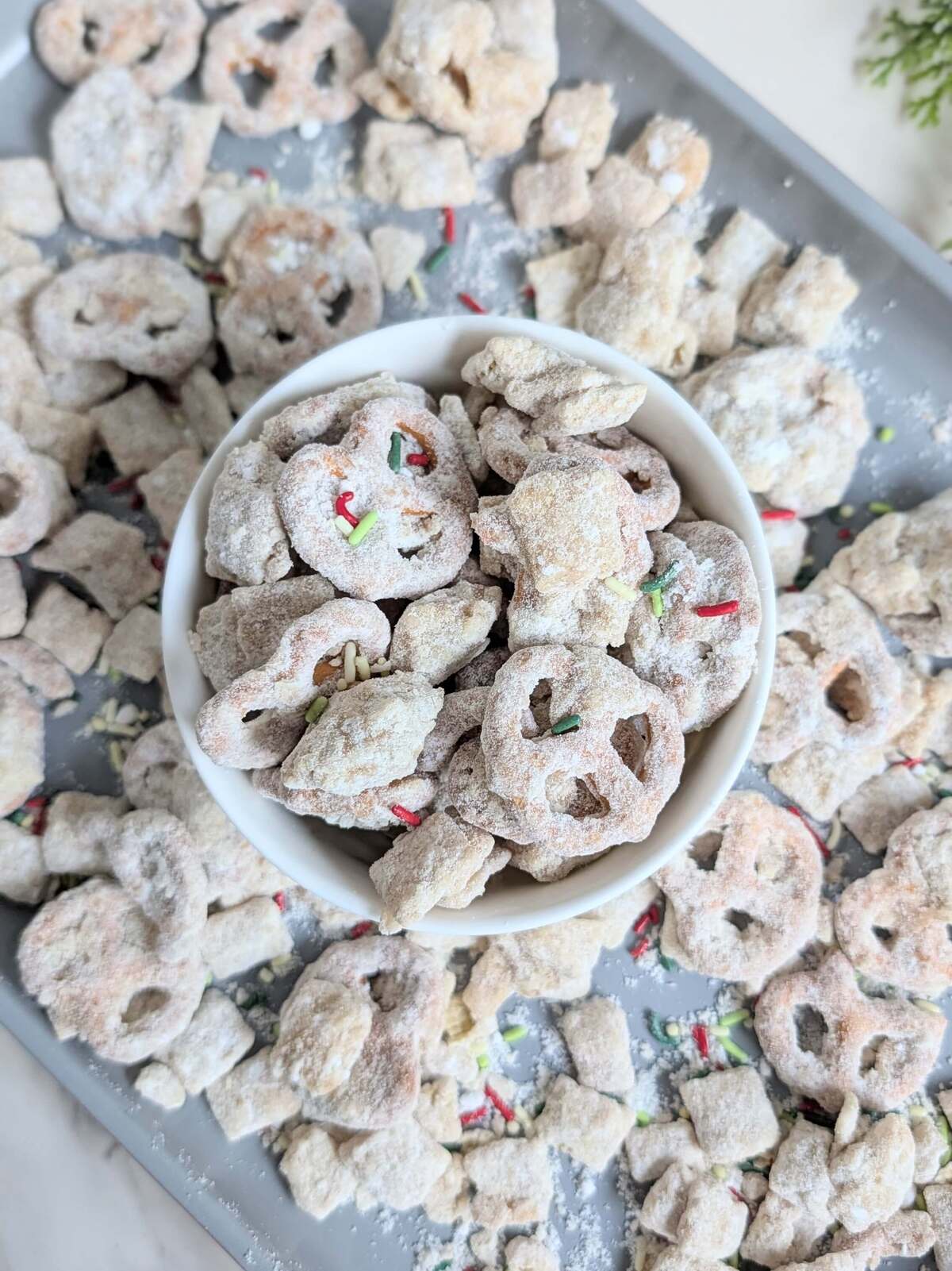 This Healthy Christmas Puppy Chow recipe is a high-protein, sugar-free version of the classic holiday reindeer muddy buddies. Made with protein pretzels, Rice Chex, and a protein white chocolate coating, it's the perfect macro-friendly festive snack!