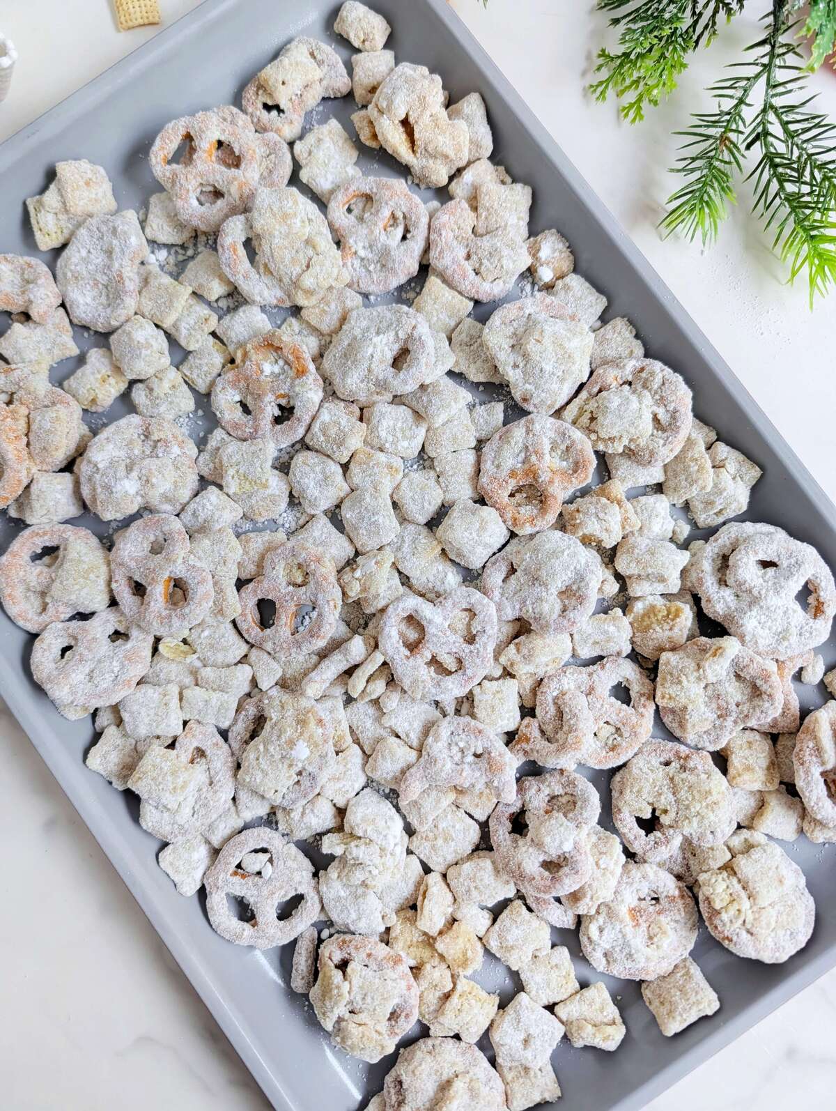This Healthy Christmas Puppy Chow recipe is a high-protein, sugar-free version of the classic holiday reindeer muddy buddies. Made with protein pretzels, Rice Chex, and a protein white chocolate coating, it's the perfect macro-friendly festive snack!