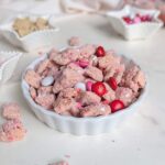 A healthy Valentine's Day Muddy Buddies recipe made with protein powder and naturally colored with freeze-dried strawberries. This Pink Puppy Chow is the perfect sweet, high-protein snack without the red food dye.