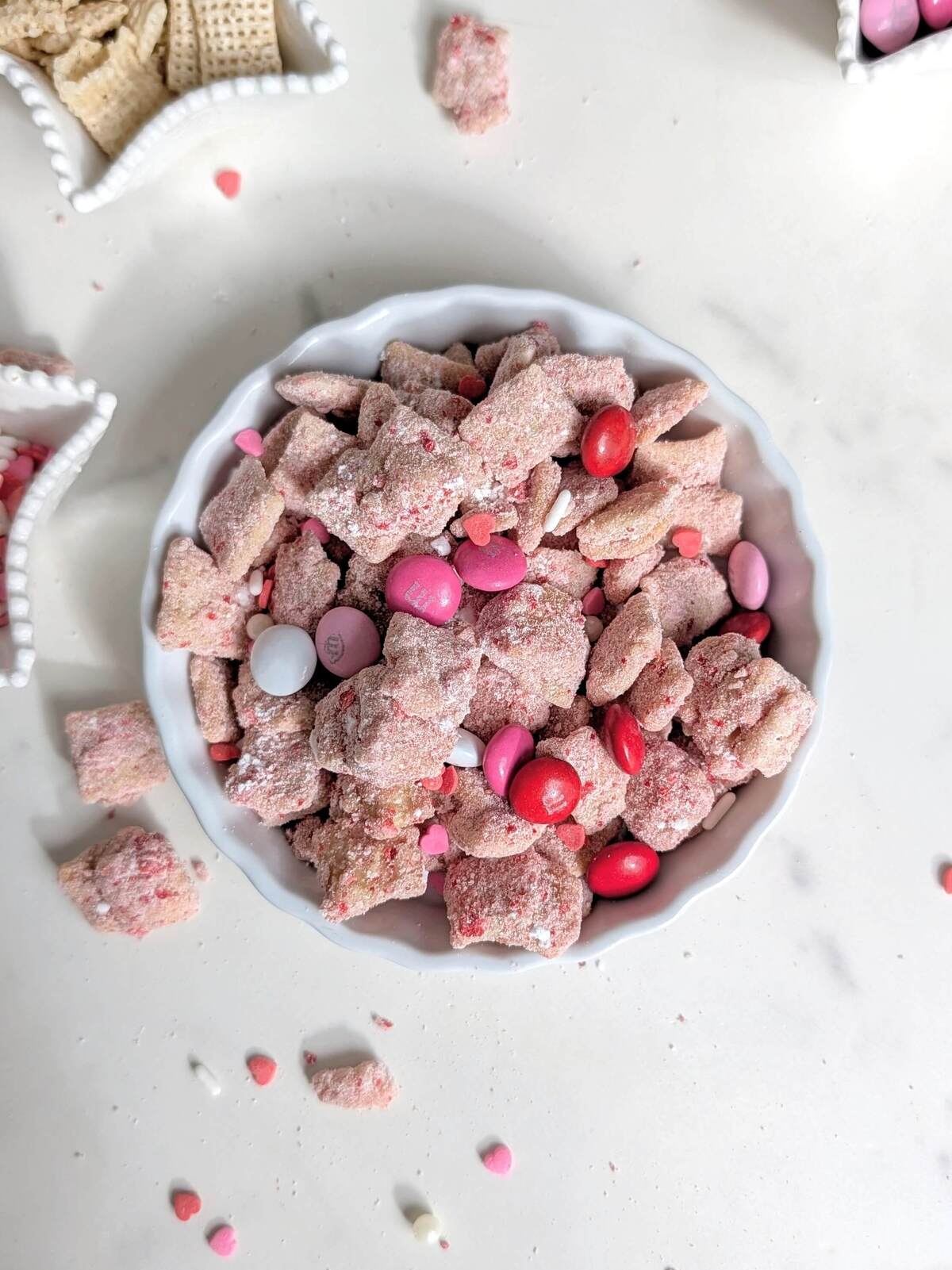A healthy Valentine's Day Muddy Buddies recipe made with protein powder and naturally colored with freeze-dried strawberries. This Pink Puppy Chow is the perfect sweet, high-protein snack without the red food dye.