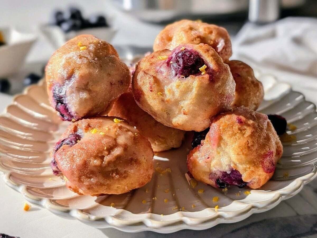Skip the deep frying with these Air Fryer Lemon Blueberry Protein Donut Holes! 5-minute cook time, no yeast, and a sugar-free glaze. The perfect low-calorie, healthy snack.
