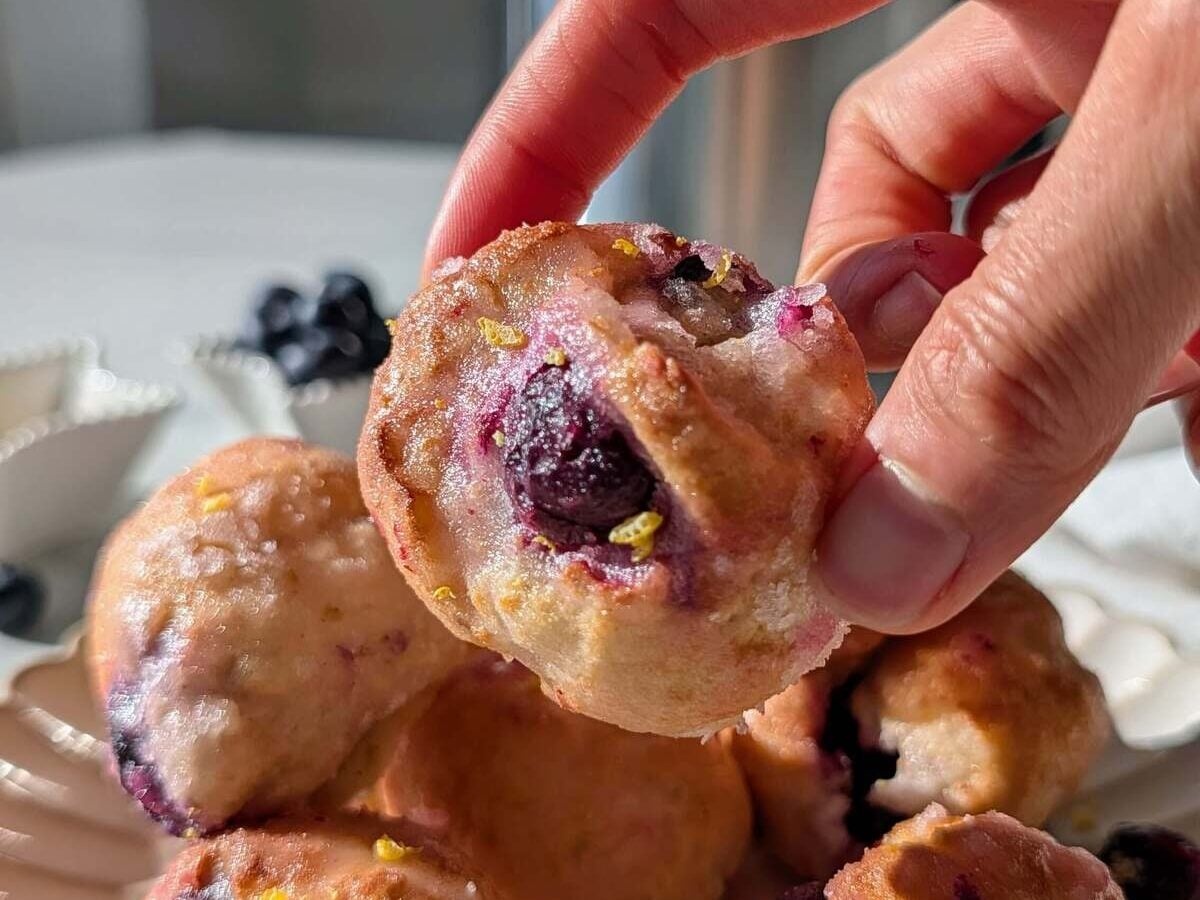 Skip the deep frying with these Air Fryer Lemon Blueberry Protein Donut Holes! 5-minute cook time, no yeast, and a sugar-free glaze. The perfect low-calorie, healthy snack.