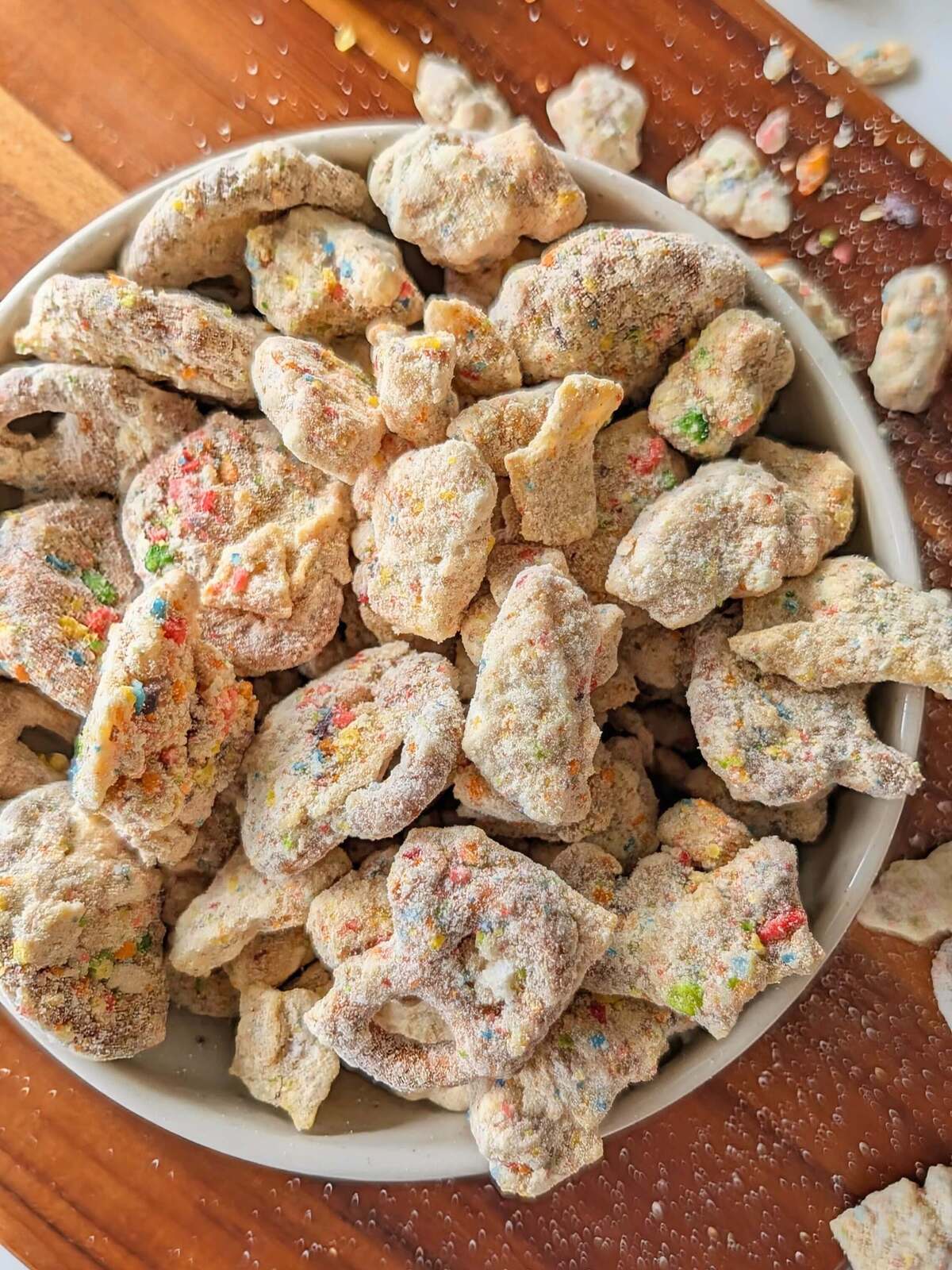 Crunchy, nostalgic Protein Fruity Pebble Puppy Chow! A high-volume, healthy rainbow muddy buddies with pretzels, rice cakes, tortilla chips and a fruity pebbles protein coating.