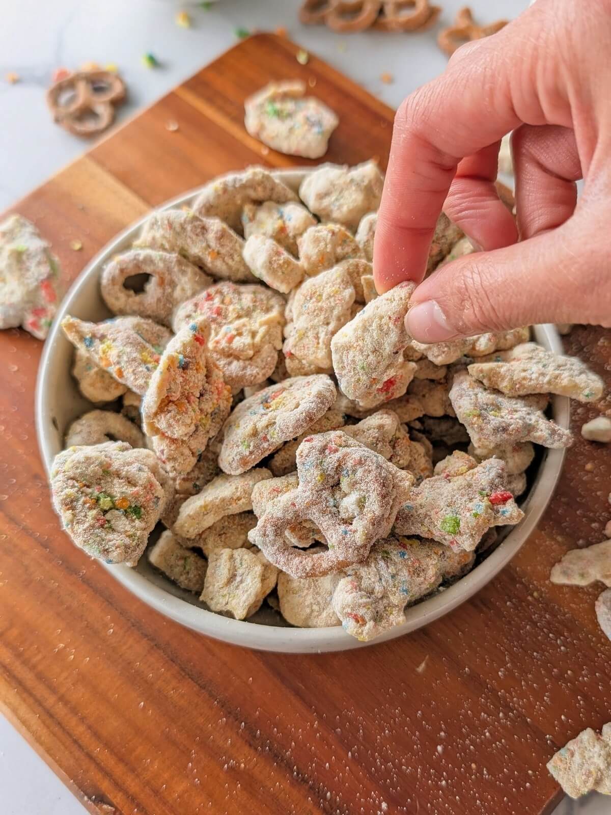 Crunchy, nostalgic Protein Fruity Pebble Puppy Chow! A high-volume, healthy rainbow muddy buddies with pretzels, rice cakes, tortilla chips and a fruity pebbles protein coating.